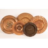 Five embossed copper chargers,