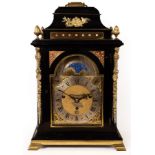 A George III ebony veneered eight-day, quarter-chime table clock by Gravell, London,