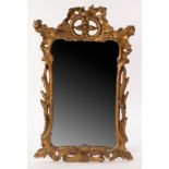 An 18th Century gilt upright wall mirror with Rococo frame, 94cm x 59.