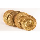 Four embossed brass chargers,