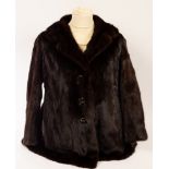 A brown fur coat by Sefton Marks of Solihull, initialled 'EH' to the inside, 85cm long,