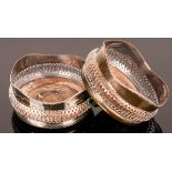 A pair of silver plated wine coasters with pierced sides and a wooden base CONDITION