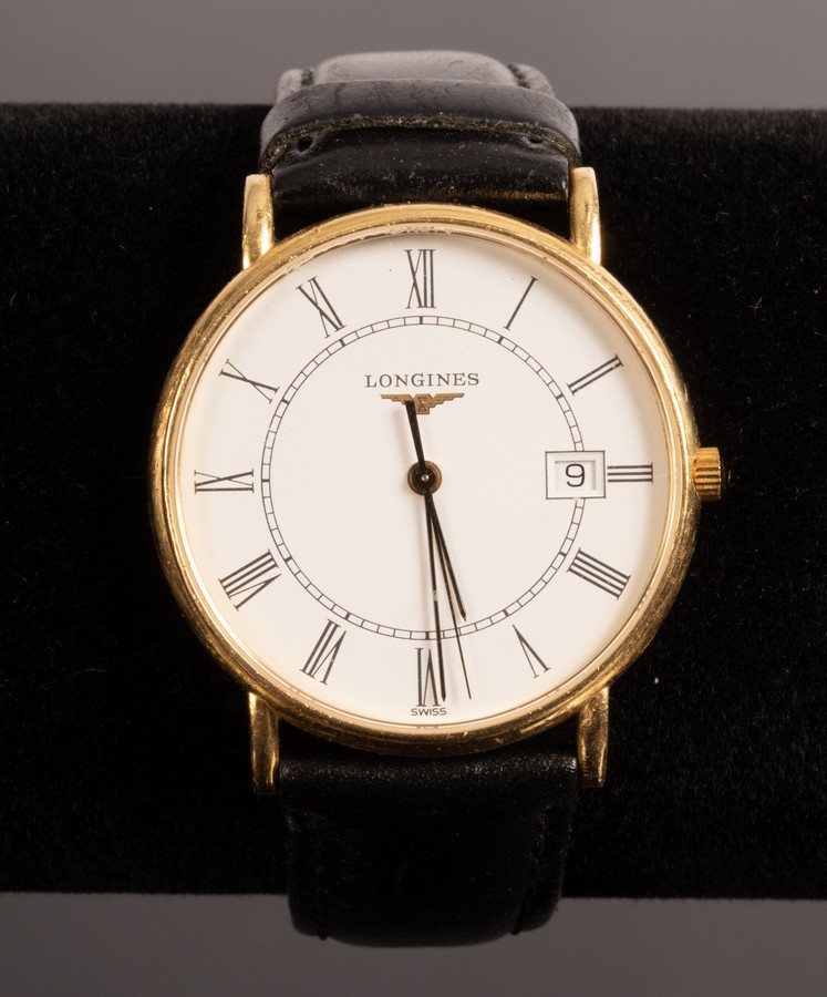 A gentleman's 18k gold cased Longines wristwatch the dial with Roman numerals and date aperture,