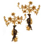 A pair of ormolu five-light wall lights with bronze putto supports,