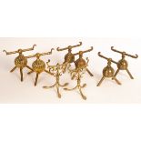 Four pairs of brass firedogs, Aesthetic movement, three with spherical bases,