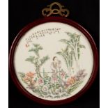 A 20th Century Chinese porcelain roundel, depicting a lady in a garden with poem, signed Yushaoping,