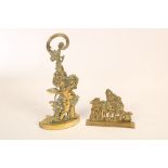 Two brass doorstops, the larger a cherub with single scrolled loop handle,