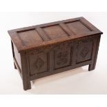 A Jacobean chest with hinged panelled top and carved and panelled front,