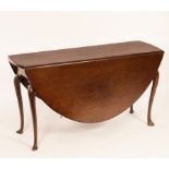 A George II mahogany two-flap dining table fitted a drawer to one end,