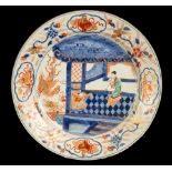 A Chinese Imari charger, decorated a woman and child in an interior, a phoenix outside,