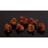 Seven Japanese carved boxwood netsuke, 20th Century, depicting dragons, foo dogs etc.