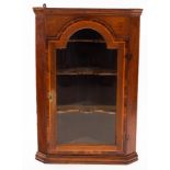 An early 19th Century later glazed hanging corner cupboard,