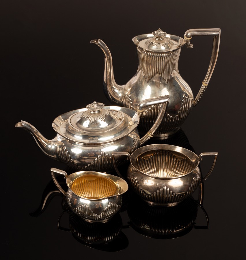 A four-piece silver tea and coffee service, BB, Birmingham 1901, half-ribbed with C scroll handles,