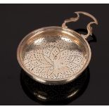 A George III silver strainer, London 1762, with pierced handle and clip, 15cm wide,