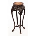 A Chinese pierced and carved hardwood jardinière stand with marble top,