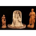 A 19th Century terracotta niche of Leda and the swan on an oval marble base and two other