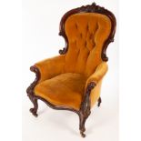 A Victorian walnut armchair with deep button back,