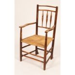 An Arts and Crafts spindle back armchair,