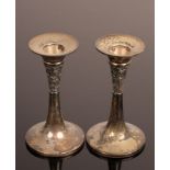 A pair silver trumpet shaped candlesticks engraved a band of flowers and foliage,