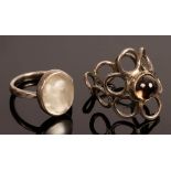 A moonstone ring by John Bartlett, the oval cabochon set in white metal, size H,