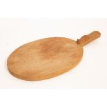 Robert Thompson of Kilburn (1876-1955), a Mouseman cheese board, in oak and of oval form,