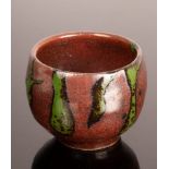 A studio pottery sake cup, red and green glazes, bears St Ives pottery mark, 5.