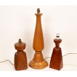 Peter Evans (died 2007), three turned wood table lamps, the largest 69cm high,
