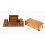 An Arts & Crafts copper desk stand with letter rack and two ink pots, embossed thistle decoration,