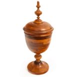 A Contemporary parquetry wooden vase and cover, 34cm high and a lacewood carved watch stand,