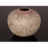 Philip Evans (born 1959), spherical vessel with textured surface, covered in pale pink glaze,