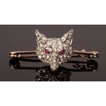 A diamond and ruby set fox mask stock pin, the pavé set mask with cabochon ruby eyes, pin 4cm,