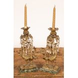 A pair of 19th Century ormolu lustres hung elongated glass drops and decorated ostriches to the
