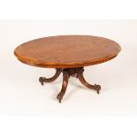 A Victorian figured walnut oval table top on a square column and quadruple base,