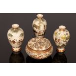 Three Meiji period Japanese Satsuma vases depicting figures in landscapes,