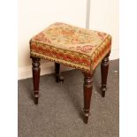 A George IV upholstered stool on turned legs,