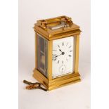 A gilt brass eight-day carriage alarm clock, half-hour repeat, hour strike,
