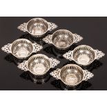 Six silver sweetmeat dishes, William Comyns, London 1896, quaich-shaped and with pierced handles,