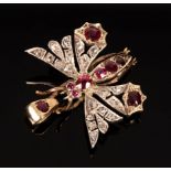 A ruby and diamond butterfly pendant, the body set with rubies,