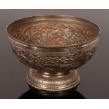 An Indian white metal bowl of circular form with pierced and embossed decoration of birds among