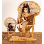 A 1920s Tokimi composition doll with jointed limbs wearing National dress and carrying a parasol,