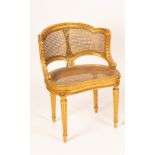 A Louis XVI style salon chair with carved scrolling frame, cane seat and back,