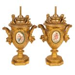 A pair of gilt metal table lamps of urn form,