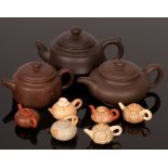 A set of Chinese miniature marble pattern tea pots in a box and three Yixing Zisha tea pots,