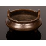 A Chinese bronze censer, 20th Century, in the style of Chongtianer, on tripod feet,