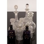 A pair of Regency cut glass half-decanters of strawberry cut mallet form with ribbed necks and cut