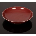 A Chinese monochrome saucer, 20th Century, in underglaze red, Hongyou,