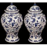 A pair of blue and white floral vase-shaped table lights and shades,