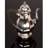 An octagonal pear-shaped silver coffee pot, Sheffield 1918, with hinged,