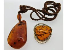A white metal mounted amber brooch twinned with an