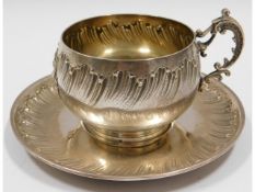 An antique French silver cup & saucer, monogrammed